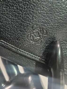 Black leather Loewe bi-fold long wallet with anagram logo.